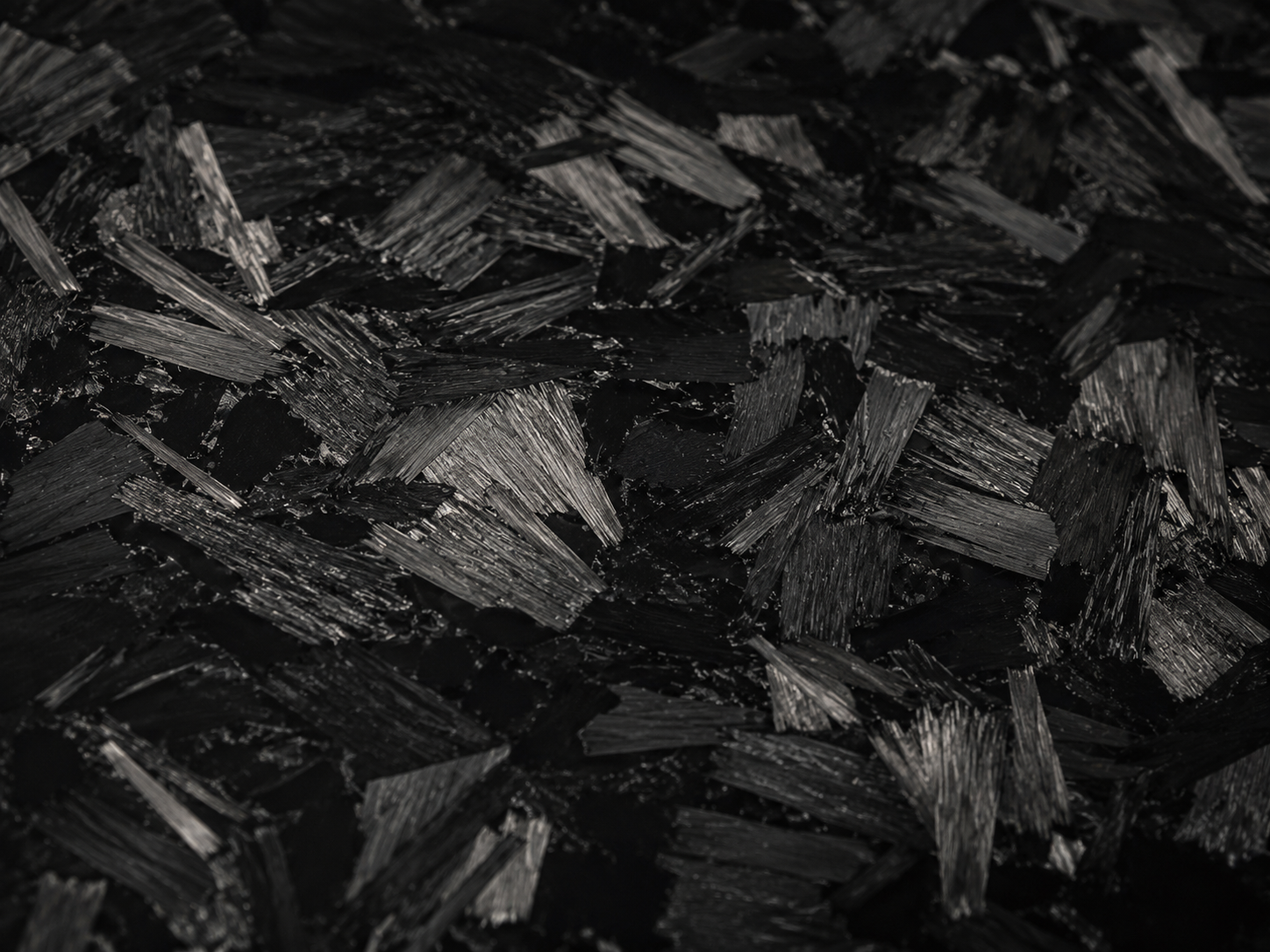 Macro detail of forged carbon fibre with randomly oriented chopped tows