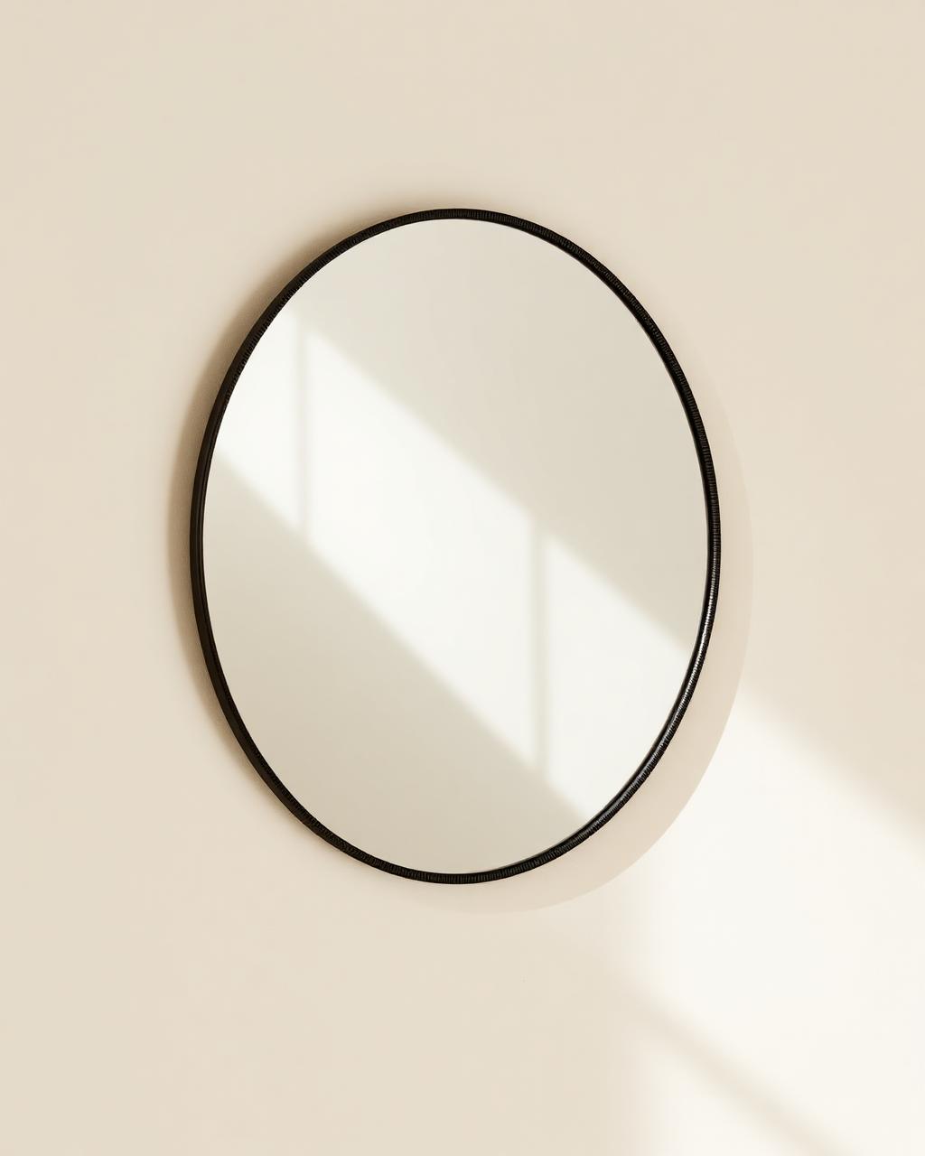 Round wall mirror with a woven carbon frame