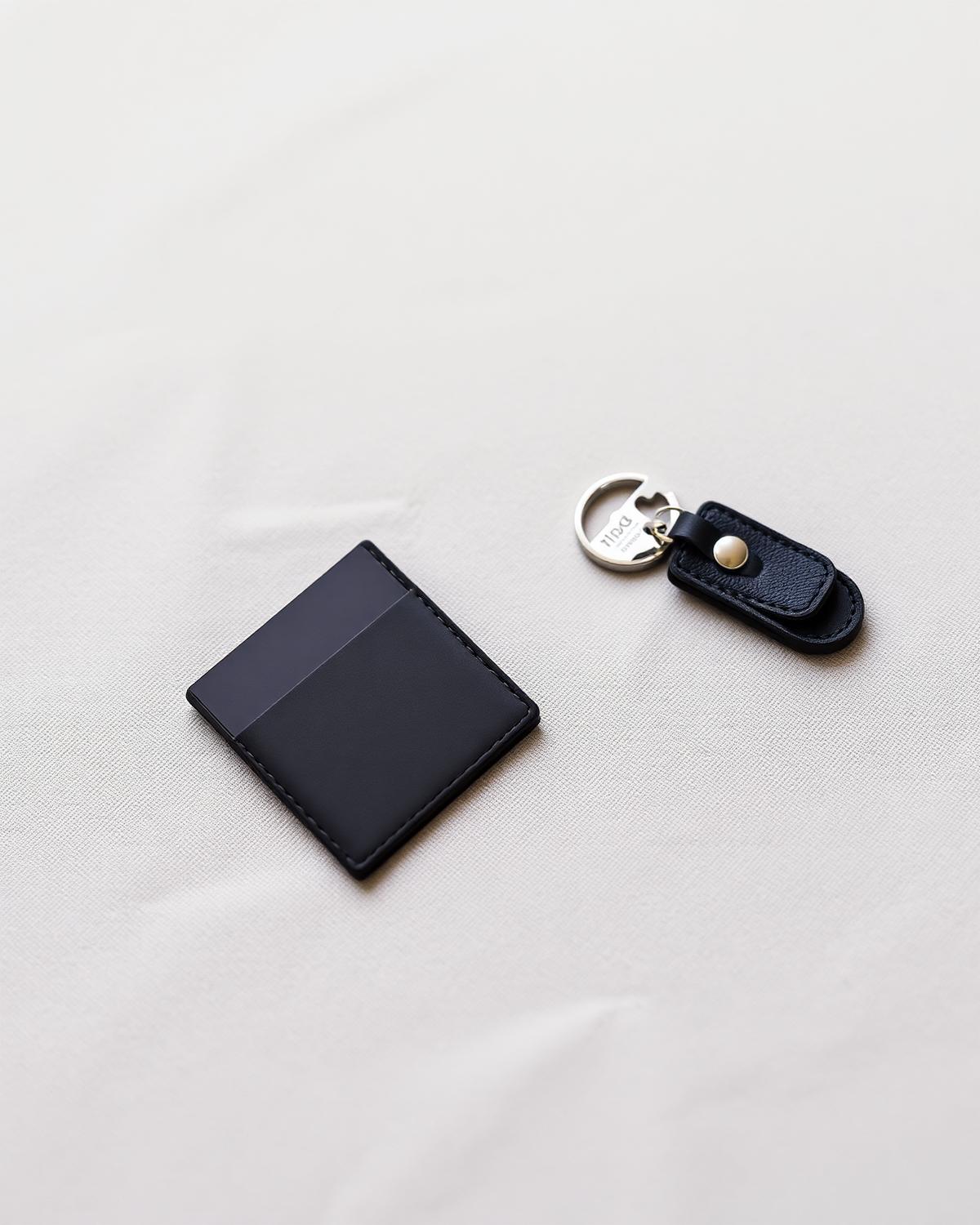 Carbon fibre card case and key vessel on linen